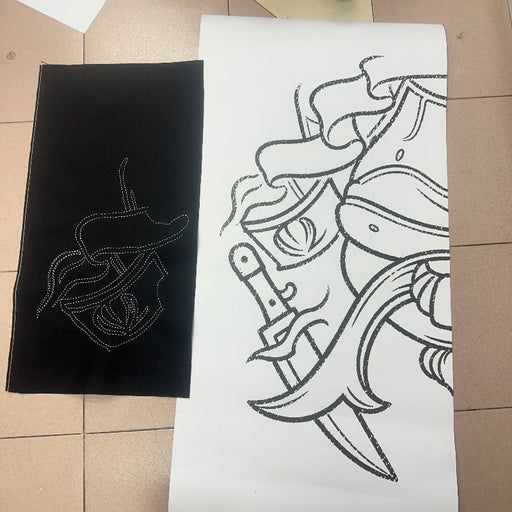 A black fabric with a white Sashiko Stitches outlined showing the matching sketch on the paper.
Done by BabyLock Sashiko BLQK Sewing Machine | Traditional Japanese Hand Stitch Machine. 